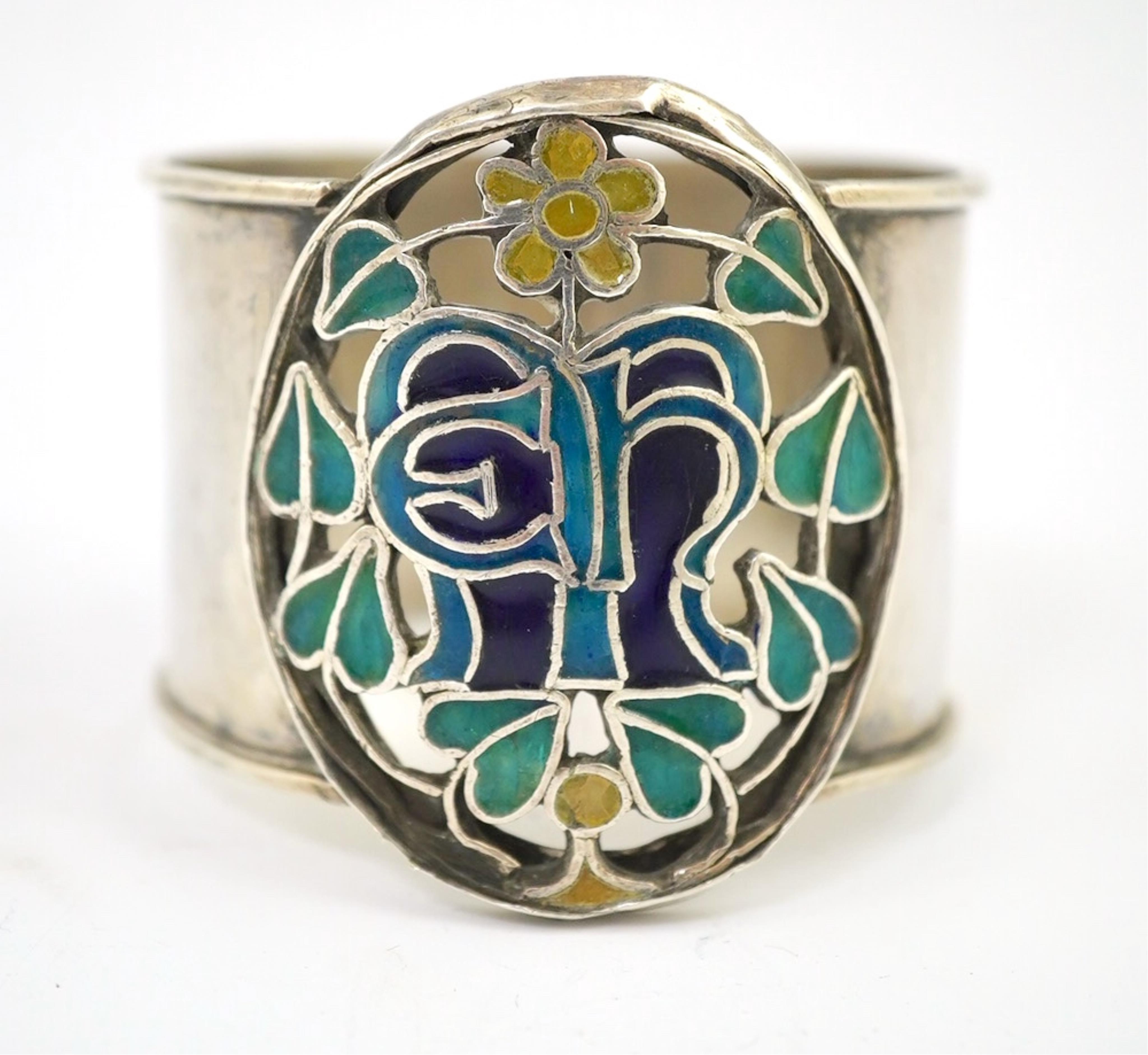 An Arts and Crafts silver and enamel napkin ring, maker’s mark LH, Birmingham 1938, 4.5cm high. Condition - fair